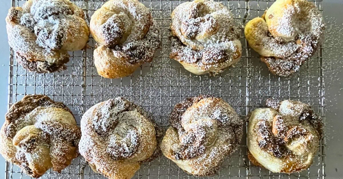 chocolate pastries with powdered sugar on top