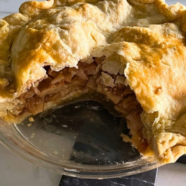 homemade apple pie sitting on a kitchen counter